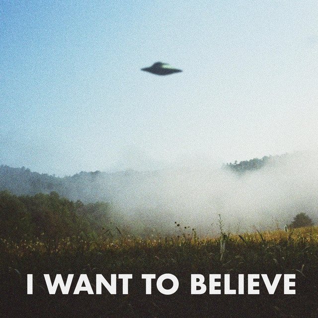 A distant flying saucer above misty hills, captioned: I want to believe